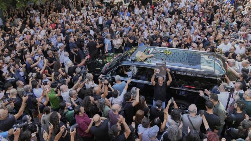 Mourners gather around an ambulance that carries the body of Ziad Rahbani, a visionary Lebanese composer, playwright, pianist and political provocateur, who died last Saturday at the age of 69, during his funeral outside a hospital in Beirut, Lebanon, Monday, July 28, 2025. (AP Photo/Hussein Malla) 3b1878d2b7.jpg