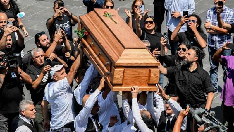 Mourners carry the coffin during the funeral of Lebanon's renowned musician and composer Ziad Rahbani at Mhaidseh's Greek Orthodox Church of Dormition in Bikfaya in Mount Lebanon, north east of Beirut, on July 28, 2025. Rahbani, son of music icon Fairuz and pioneer of Oriental jazz, died on July 26 aged 69 after revolutionising Lebanese theatre and music, starting his career at 17 in the early 1970s. The enfant terrible of Lebanese music who made a huge mark on generations of Arabs with his theatre pieces and songs, had long suffered from health problems. (Photo by JOSEPH EID / AFP) 4272aed544.jpg